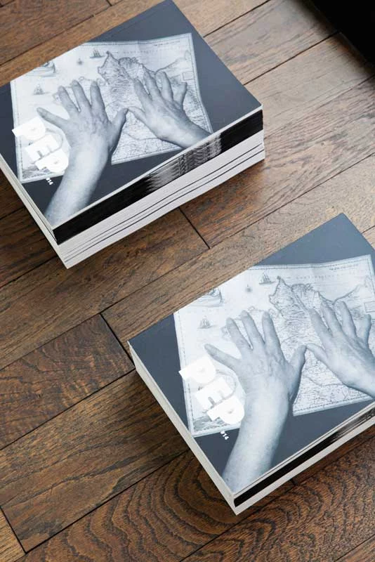 PEP Photographic Exploration Project catalogues Two piles of PEP Photographic Exploration Project catalogues on a wooden table